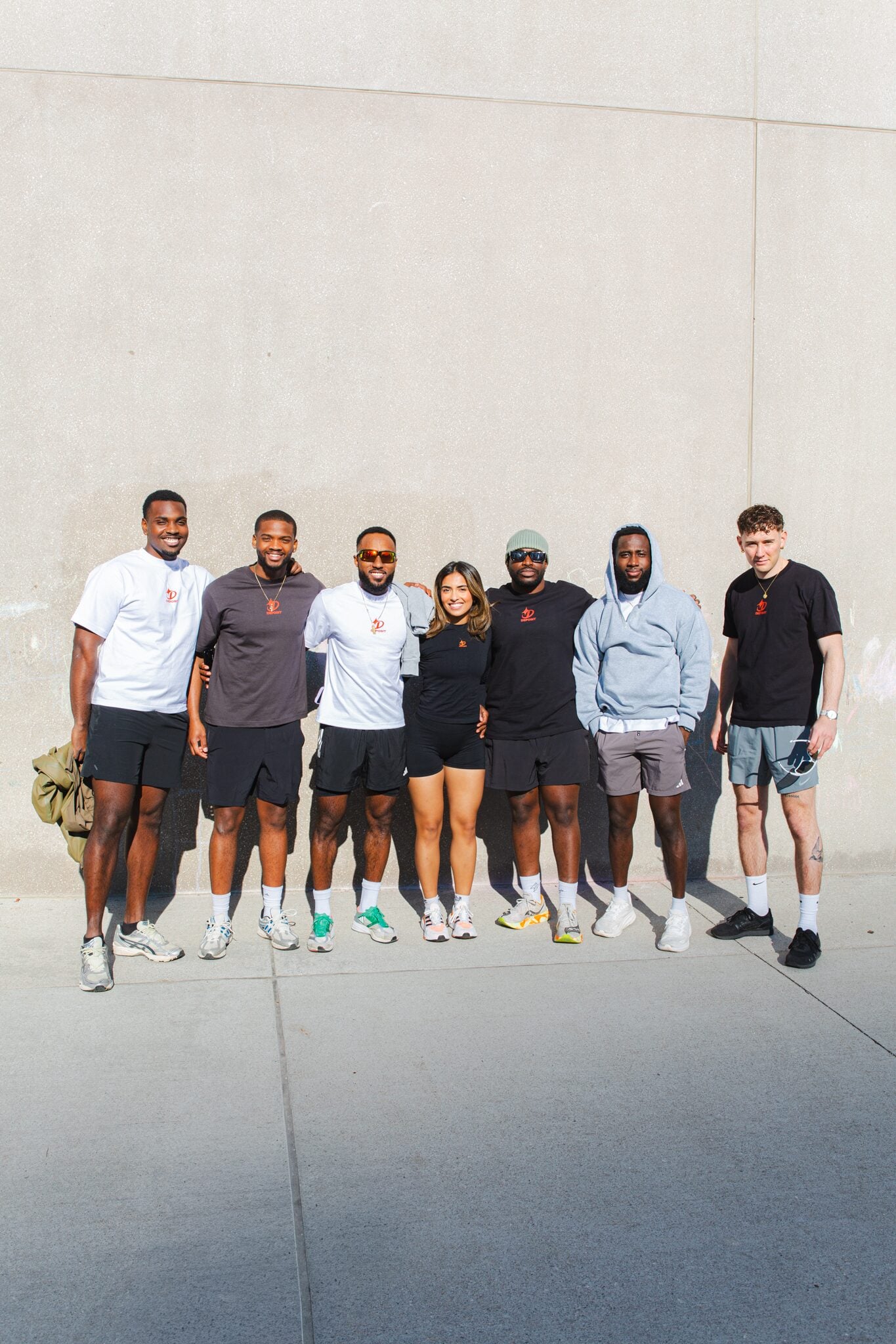Full Deposit Society team lineup against a concrete wall.